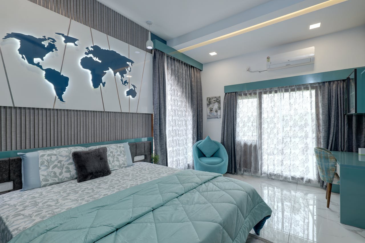 gallery-1 Stylish bedroom in Kochi with teal accents and world map decor.