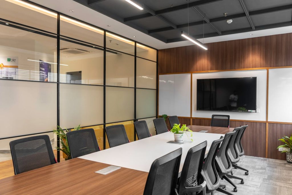 Spacious, stylish office meeting room with large table, chairs, and modern decor in Sahibzada Ajit Singh Nagar, India.