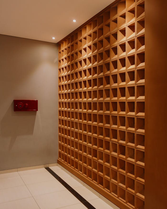 contact-img Stylish modern interior featuring a geometric wooden wall pattern and ambient lighting.